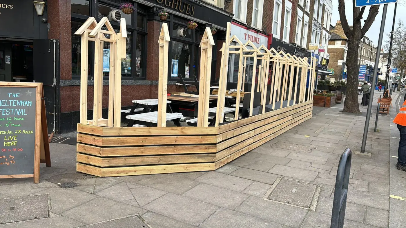 Timber enclosure and framing outside the pub